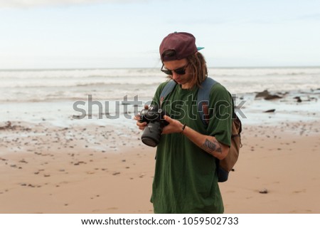 A beautiful photographer on the ocean sees his photos