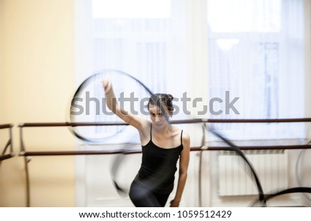 Portrait of cut Pretty rhythmic gymnast girl exercising with ribbon