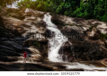 Water fall with photographer and beautiful view nature dark color style, Karom water fall, Nakhon si thammarat Thailand