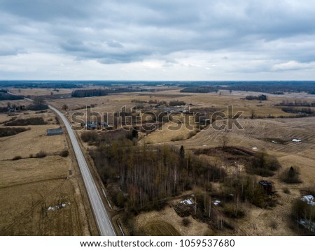 drone image. aerial view of rural area with houses and road network. populated area Dubulti near Jekabpils, Latvia. spring day, clear fields