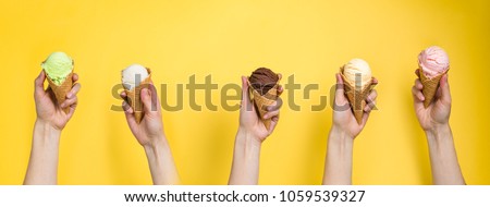 Hands holding ice cream in cones
