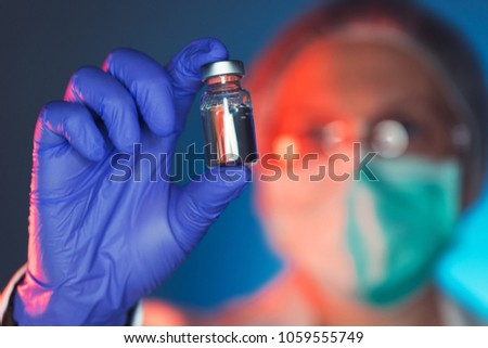 Immunologist holding phial, female medicine and health care worker in hospital clinic Royalty-Free Stock Photo #1059555749