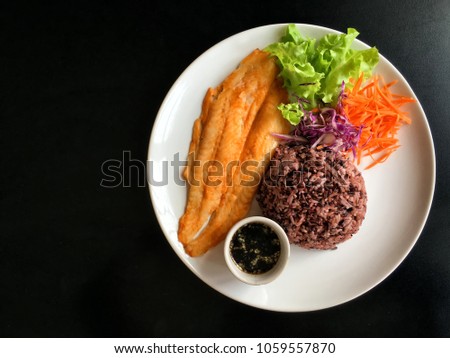 Grilled Pangasius Fillet with riceberry and japan shoyu sauce. Healthy food for dieting people.