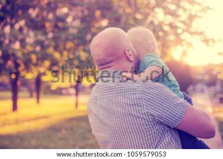 father and son over summer landscape nature background