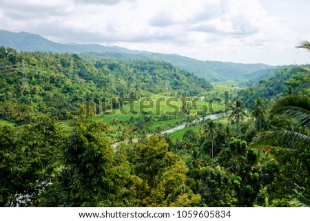 Beautiful lanscape with green valley, rice fields and mountains. Bali Indonesia.