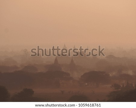 Silhouette of stupas and temples over at Bagan, an ancient city with thousands of stupas, in misty foggy morning, Myanmar 
