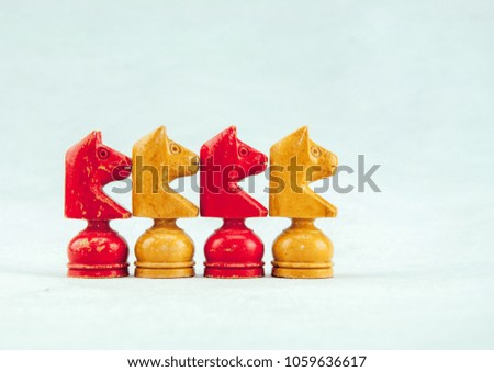 red and yellow chess pieces on white background