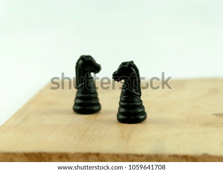 black Horses pieces on wood board