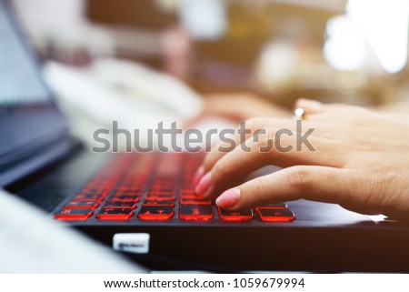A woman is using a laptop. A woman is typing on a computer notebook.                              