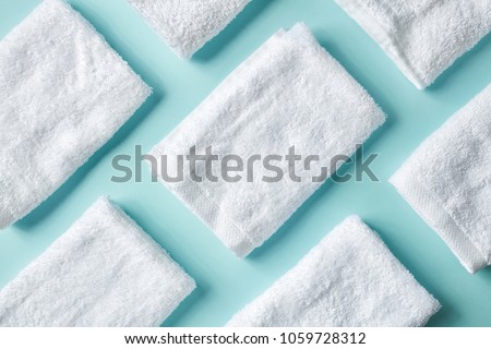 White spa towels on light blue background, top view Royalty-Free Stock Photo #1059728312