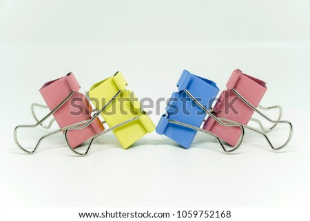 Paper clips in various colour over white background