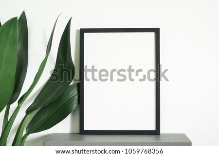 Frame poster with green leaf plant with decoration at home
