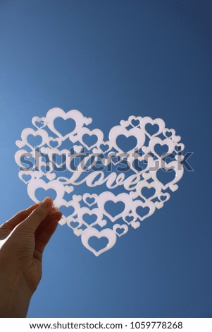 Valentines Day Heart Made of white acrylic cutting love shape Isolated on blue sky background.