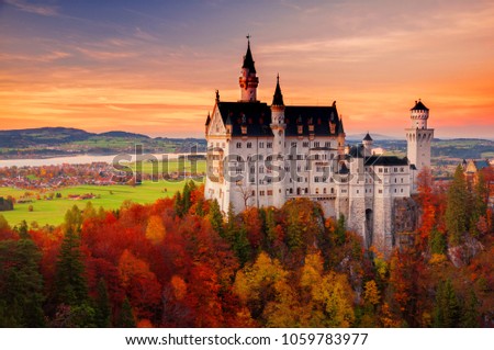 Scenic sunset view on Neuschwanstein Castle with colorful sky and autumn trees. Bavaria, Germany. Royalty-Free Stock Photo #1059783977