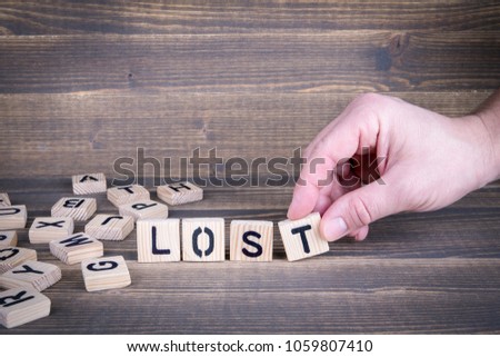 Lost. Wooden letters on the office desk, informative and communication background