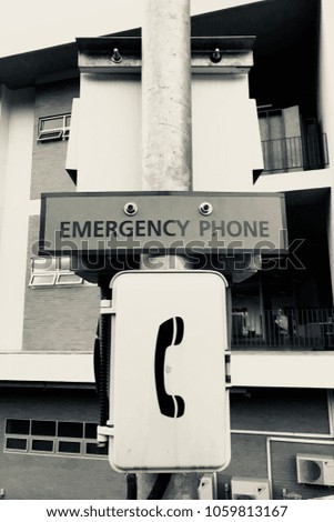 Portrait emergency phone on a pole in monochrome toning