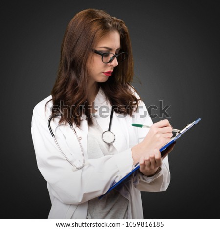 Doctor woman holding a folder on black background