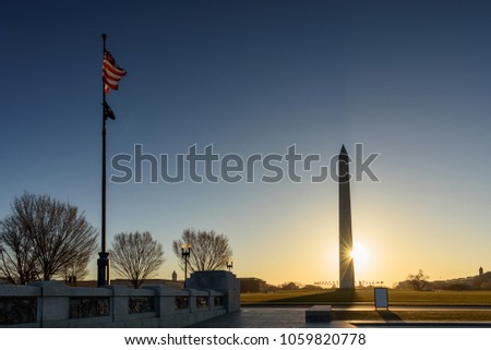 View of Amrican flag and Washington Monument at Sunrise view from National World War II Memorial, Washington DC