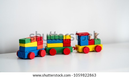 baby wooden toy train set on white background. colorful