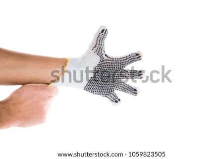 Side view of beautiful human hand palm dressed in new nice and soft natural cotton fabric glove isolated on abstract white background. Wearing and special clothes concept. Detailed closeup studio shot