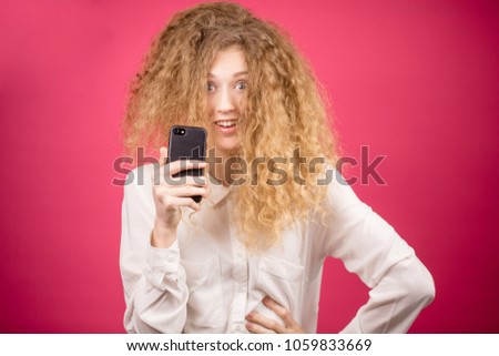 young office worker with unusual hairstyle is taking pictures of herself