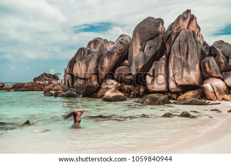 Young woman during vacation at Anse cocos beach , tropical island La Digue Seychelles , woman in bikine at the beach at holiday
