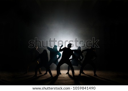 young people are preparing for concert on the blach background.dancing hip hop at darkness Royalty-Free Stock Photo #1059841490