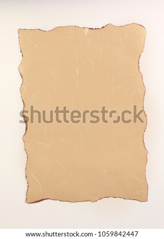 burnt sheet of paper on a white background
