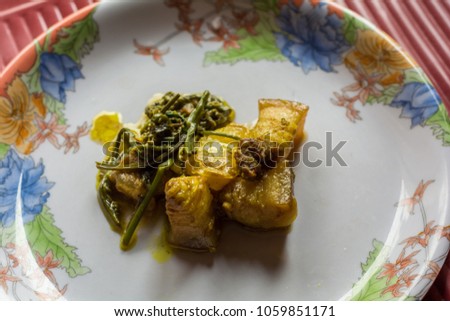 pork with Fiddlehead fern. Assamese cuisine. Indian food. traditional Assamese pork disk.