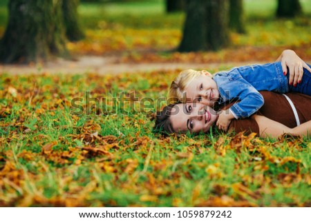 beautiful young mother daughter relaxing sitting grass background summer meadow green grass trees
