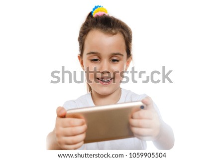 little girl is looking the cartoon on the mobile phone in the white wall background concept