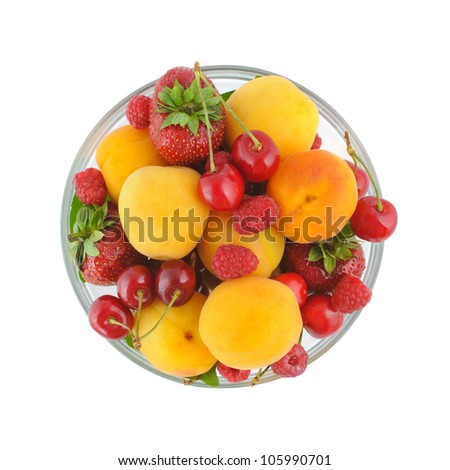 Glass bowl full of a variety of fresh berries. Top view, isolated on white with clipping path. Royalty-Free Stock Photo #105990701