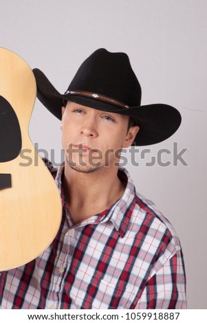 Thoughtful cowboy with a guitar