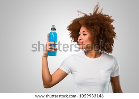 young fitness afro woman drinking an energy drink