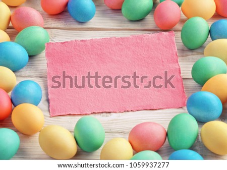 Easter background with Easter eggs and spring flowers. Top view with copy space.