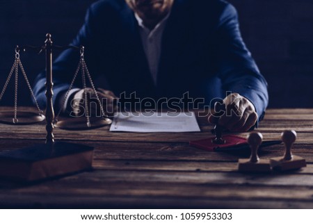 Notary public notarizes document in his office. Law concept