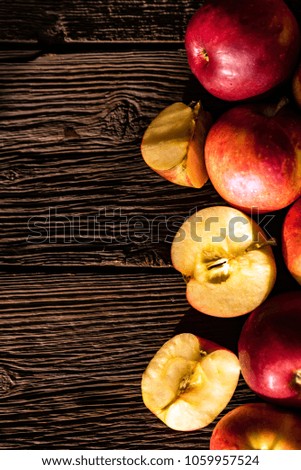 Background of apples whole and cut on wood