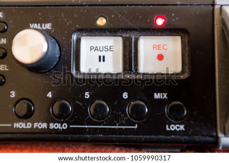 Close up of a REC record button on a sound recorder, audio portable recorder for recording live audio, used for film or TV set