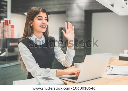 The beautiful businesswoman gesturing at the desktop