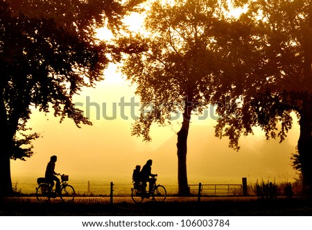 Silhouette of two bicyclers at sunset