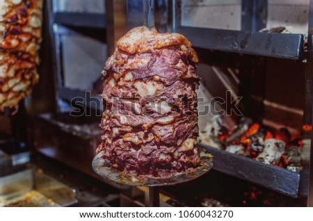 Close up shot of stacked meat roasting to be used in preparation of traditional Greek dish gyros or Turkish durum doner. shawarma
