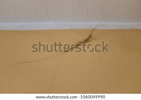 Corner of the ceiling in a room with dark dirty black spider web, mold and dust