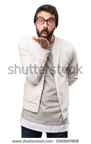 Hipster man sending a kiss on white background