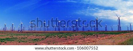 Picture of modern production of electricity - a powerful wind turbines in the background of beautiful nature