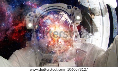 Astronaut in outer space. Science fiction art. Elements of this image furnished by NASA.