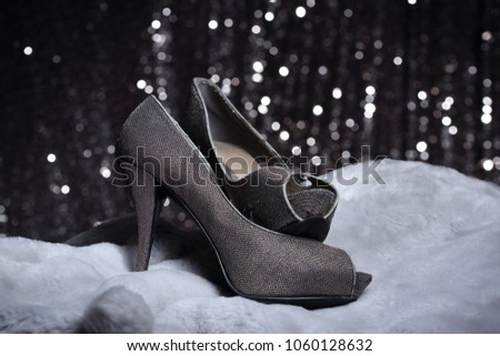 Gray weaving high heel woman Shoes on fur fabric wave with textured glitter bokeh bubble backgrounds, copy space advertising text logo greeting, congratulations, holidays, jewelry and luxury concept