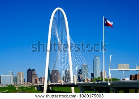 Dallas, Texas Skyline with Margaret Hunt Hill Bridge in the foreground. Clear blue sky background.