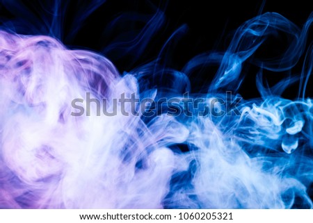 Colorful  blue smoke on a black isolated background. Background from the smoke of vape