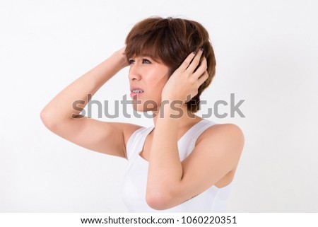Health and pain. Stressed exhausted young woman having strong tension headache.  Isolated on white background. Studio lighting. Concept for healthy and medical