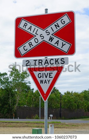 Road sign warning of train railroad crossing